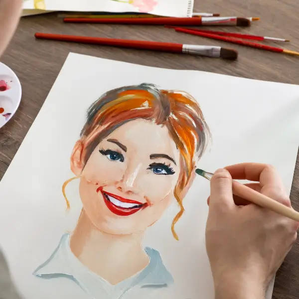Person painting a nice portrait of their friend on paper canvas